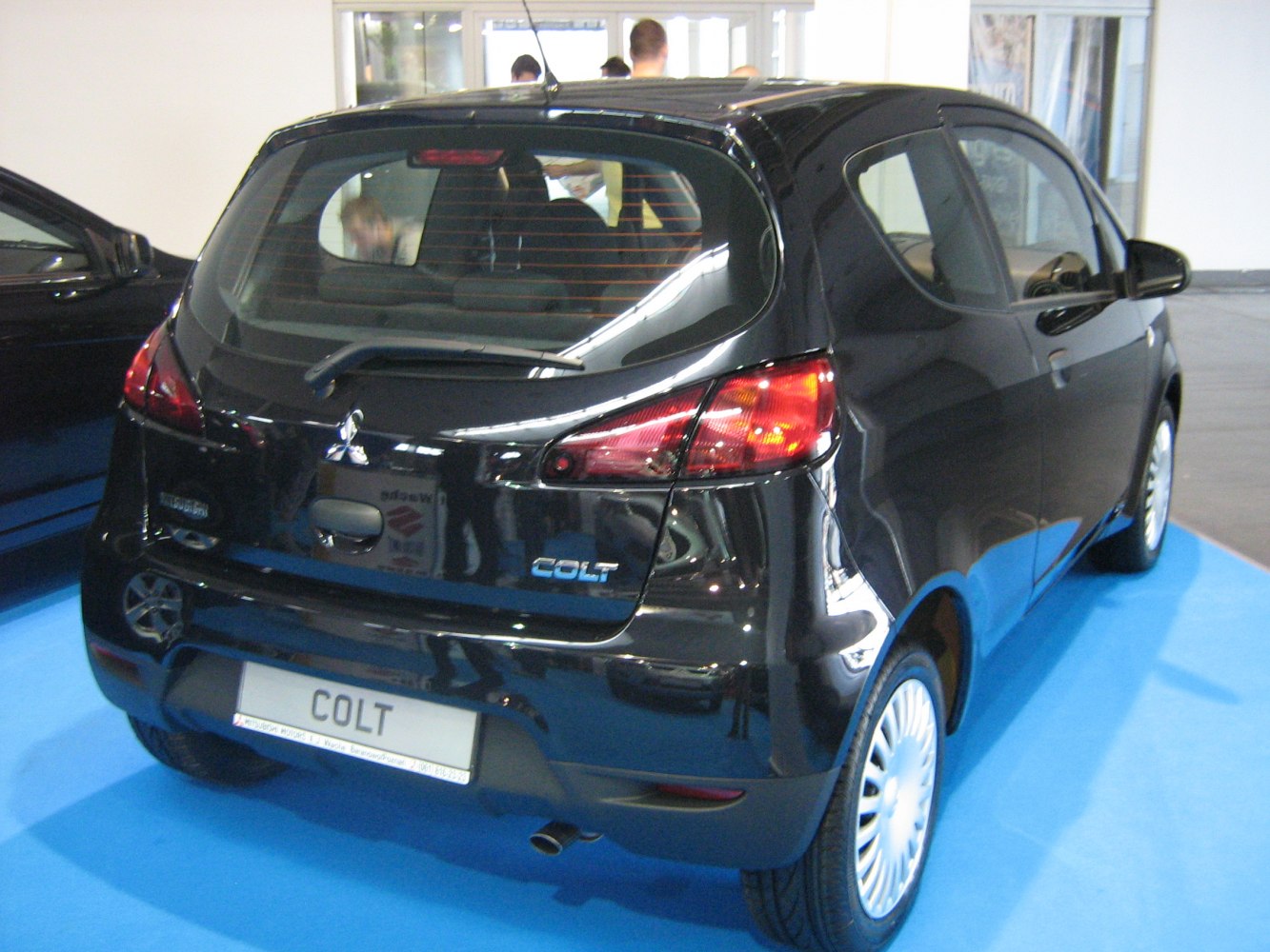 Rear view of a compact 3-door hatchback with distinctive taillights and rear wiper