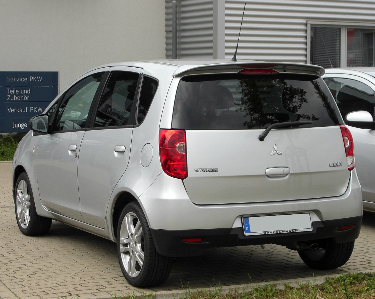 Compact hatchback rear with taillights, rear wiper, and alloy wheels
