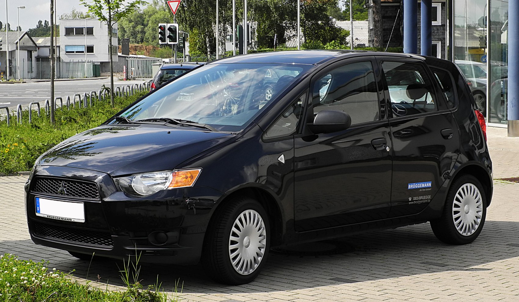 Front and side view of a black compact hatchback with distinctive headlights