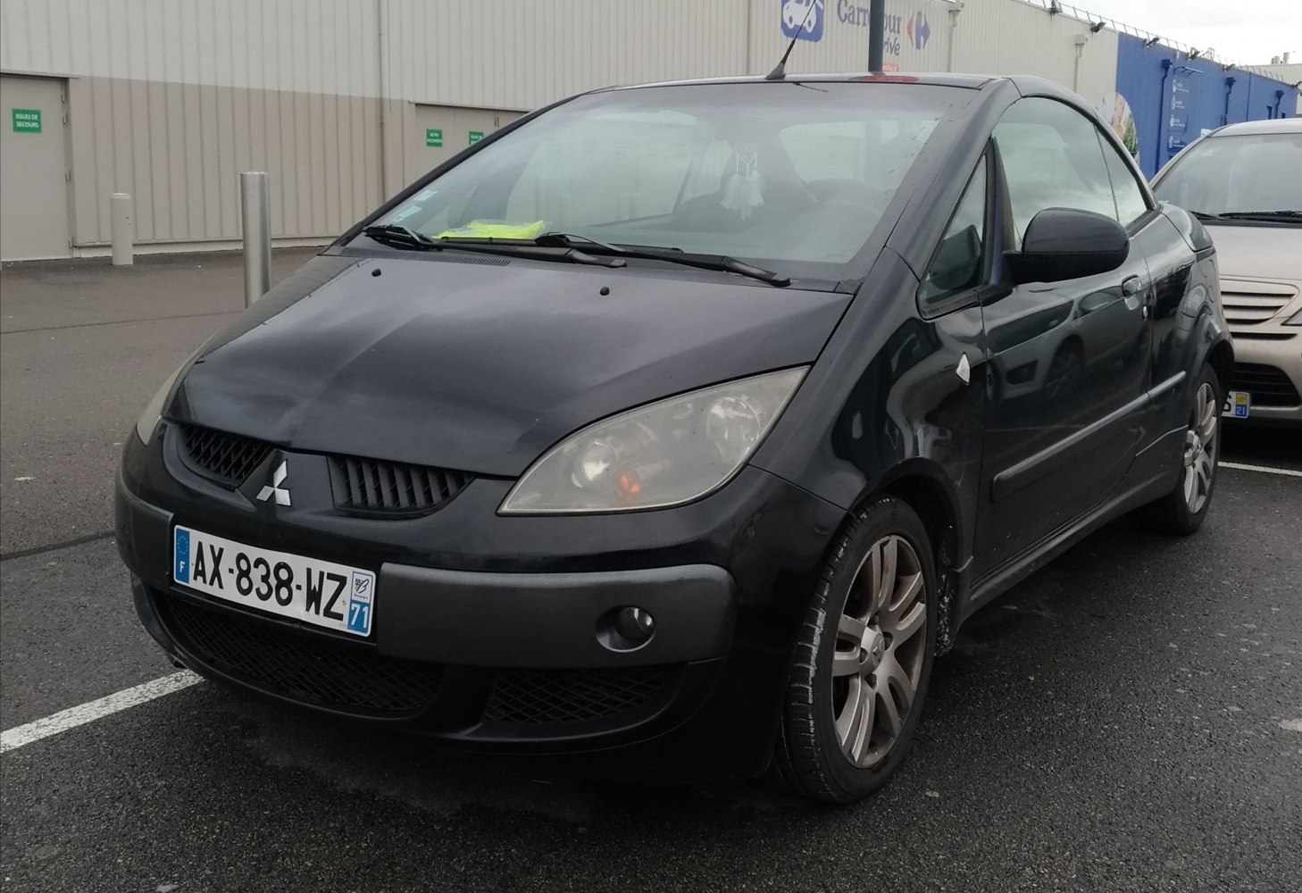Front-side view showing distinctive headlights and grille of compact hatchback
