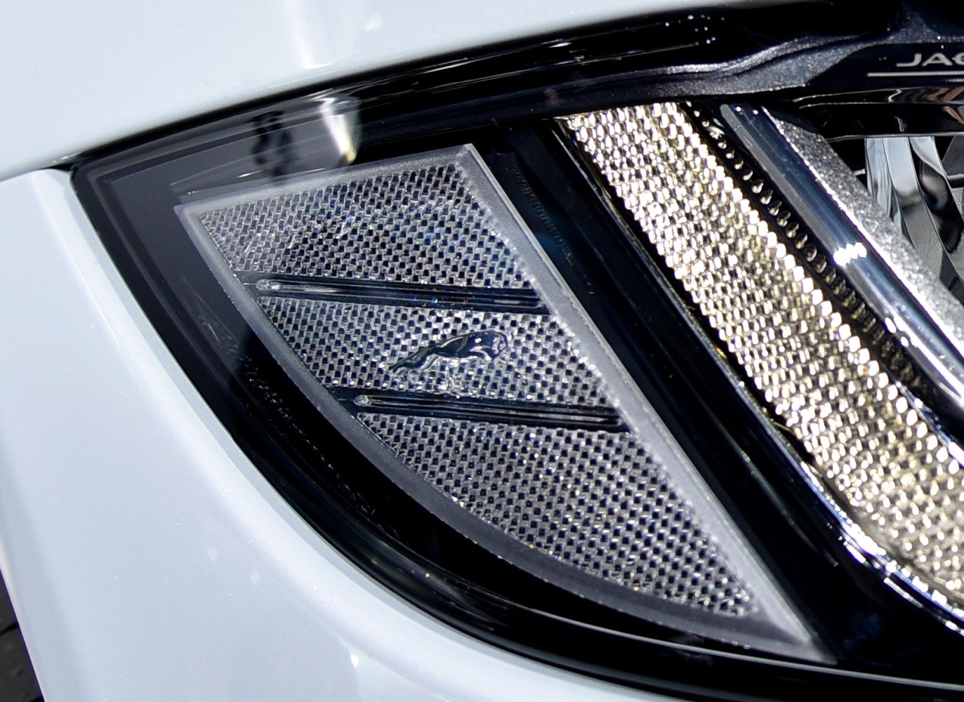 Close-up view of a modern car's headlight and grille detail