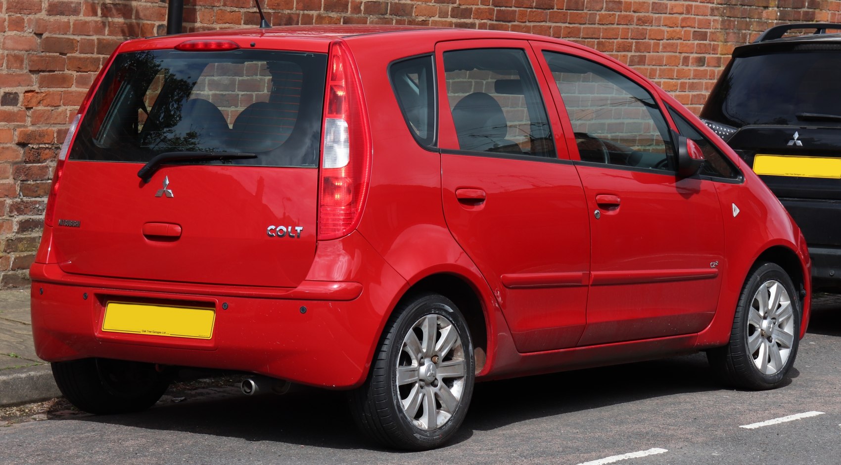 Red hatchback rear with vertical tail lights and rear windshield wiper