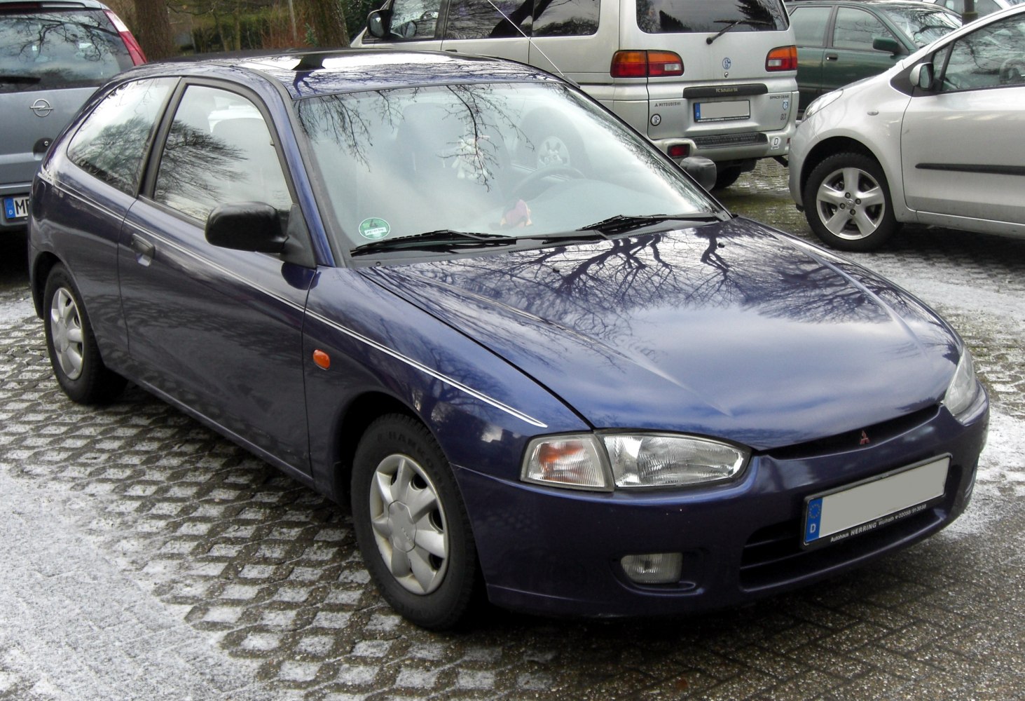 Compact hatchback with clear headlights and sleek front profile