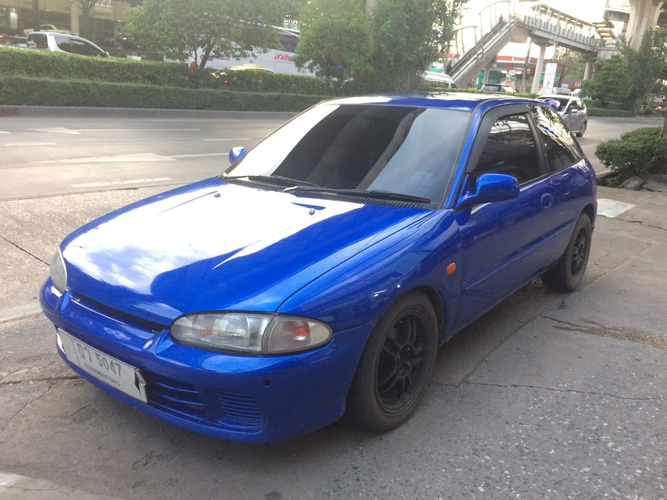 Compact hatchback with black wheels and tinted windows