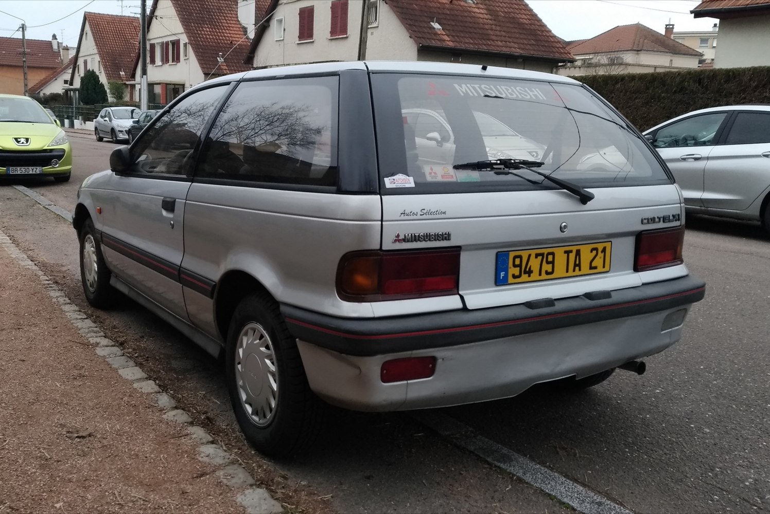 Rear angle of vintage compact hatchback with large windows and black trim