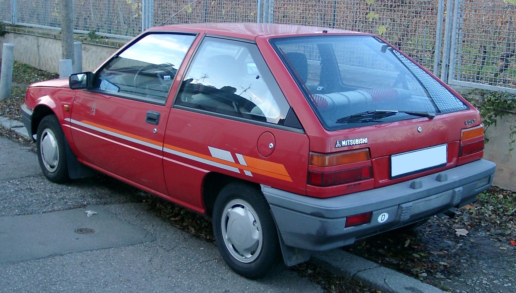 Two-door hatchback with rear hatch and distinctive side decals