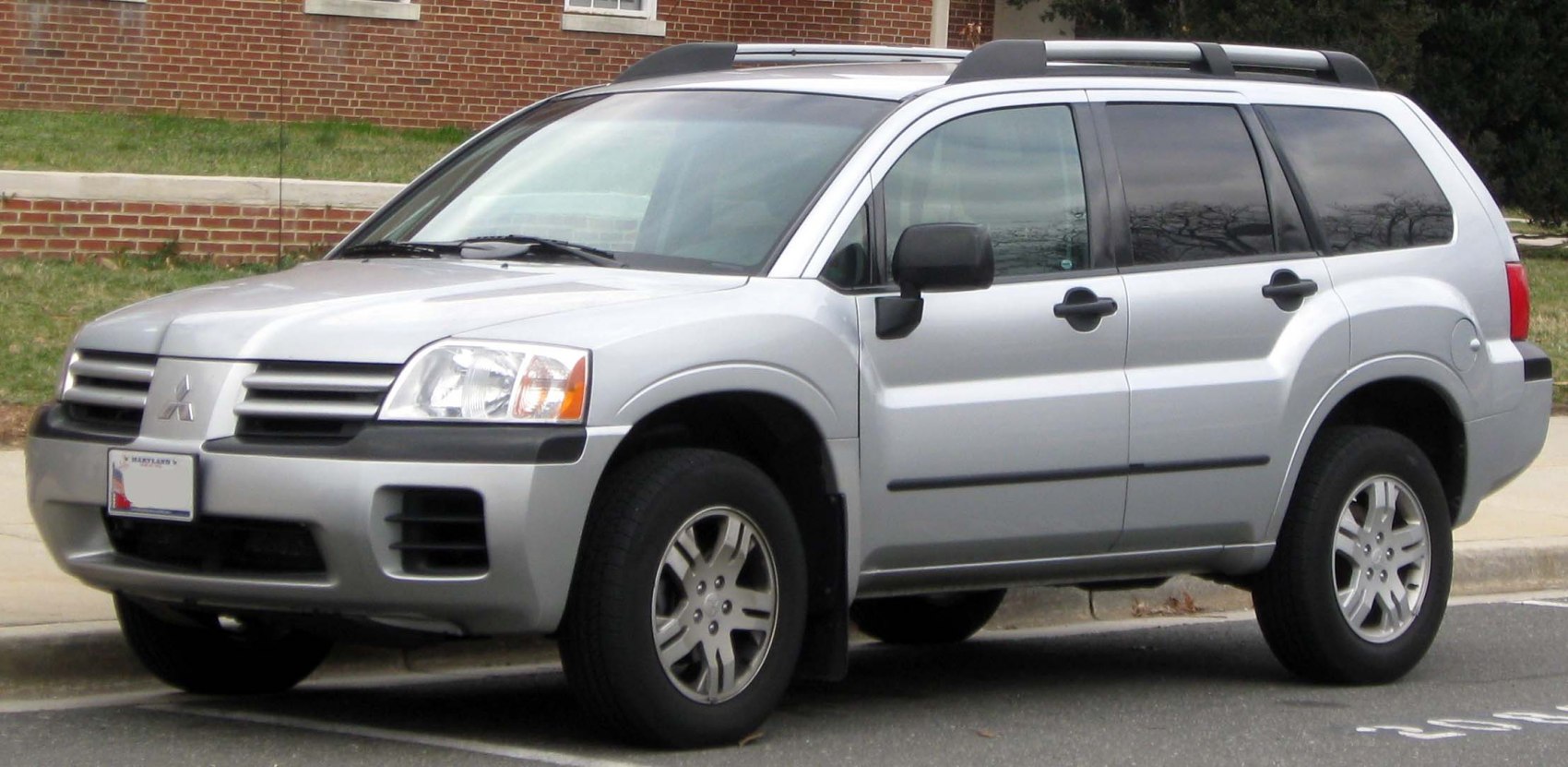 Front-side view of a mid-size silver SUV with roof rails and alloy wheels