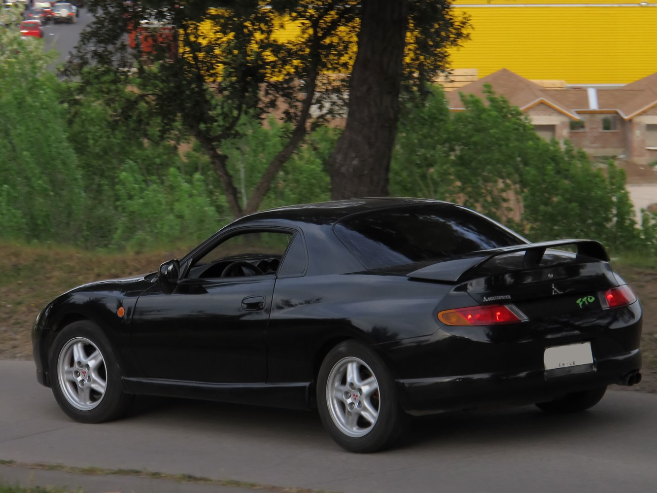 Black sports coupe rear side with spoiler and alloy wheels