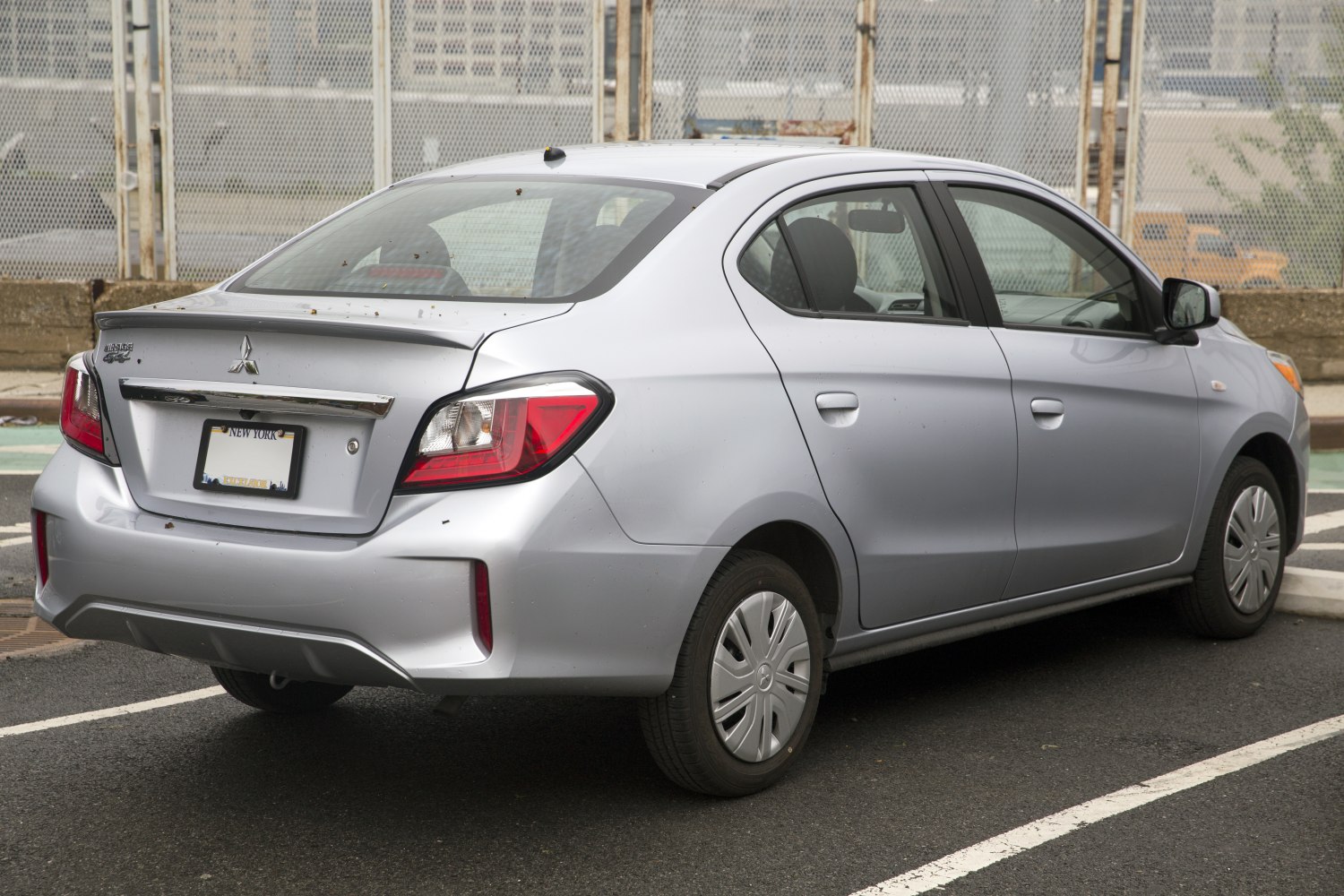 Rear sedan view with tail lights and spoiler