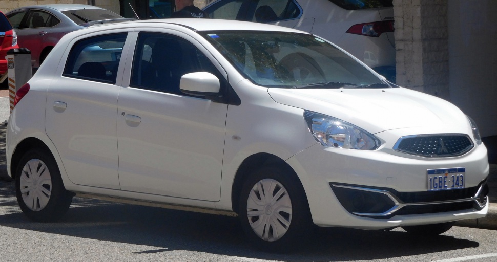 Compact hatchback front-side view with headlight and grille details