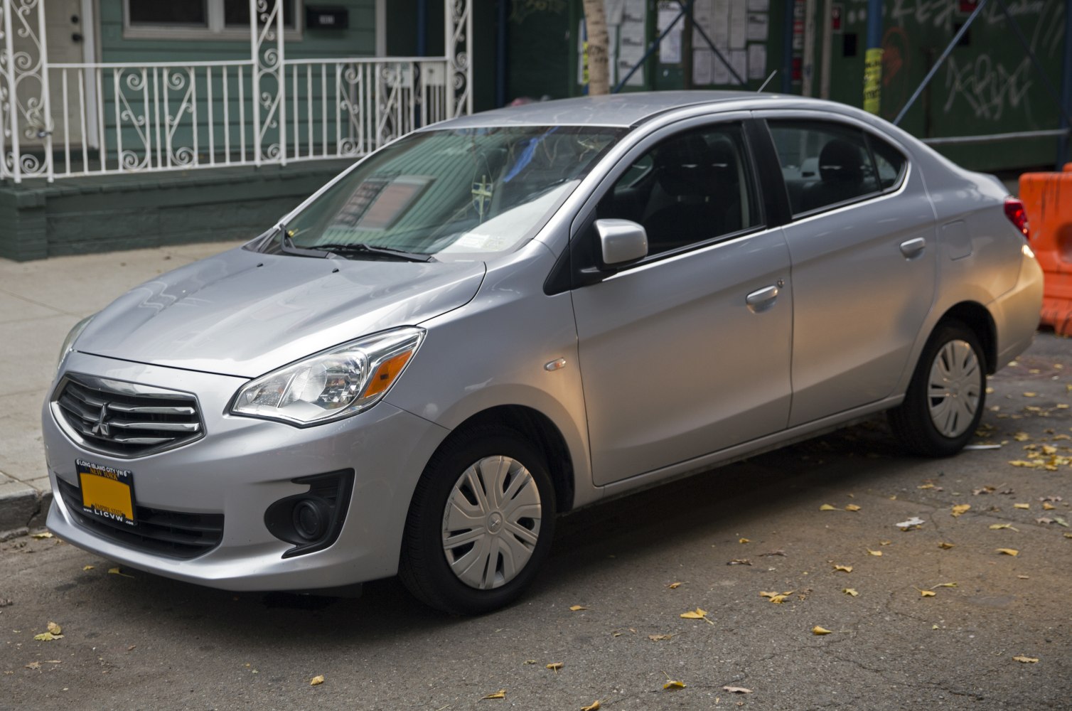 Silver compact sedan with sleek headlights and aerodynamic design