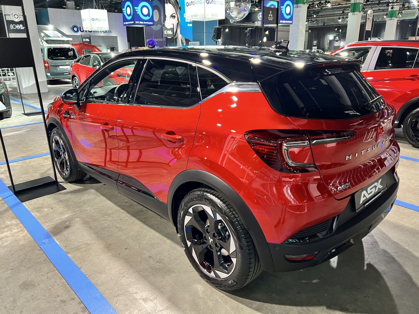 Red two-tone compact SUV rear and side with modern taillights and black roof