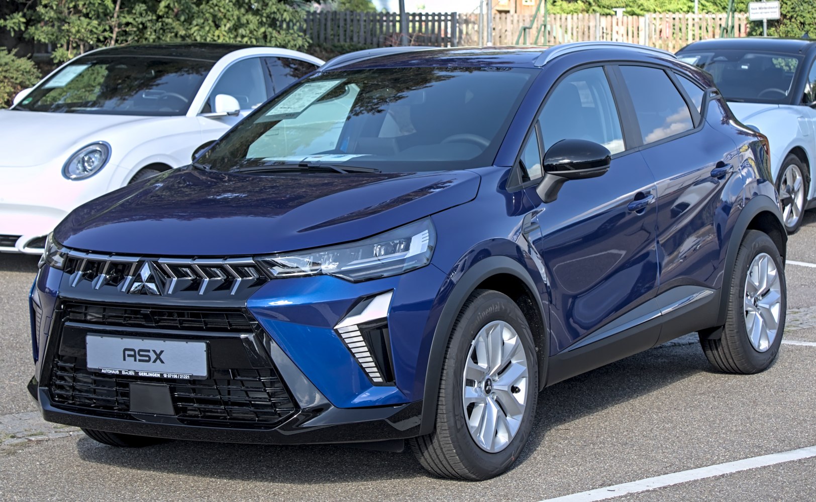 Front view with modern LED headlights and distinctive grille design