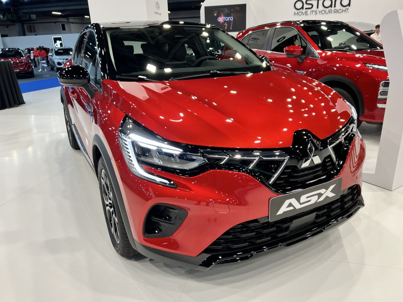 Close-up of LED headlights and front grille on red compact SUV