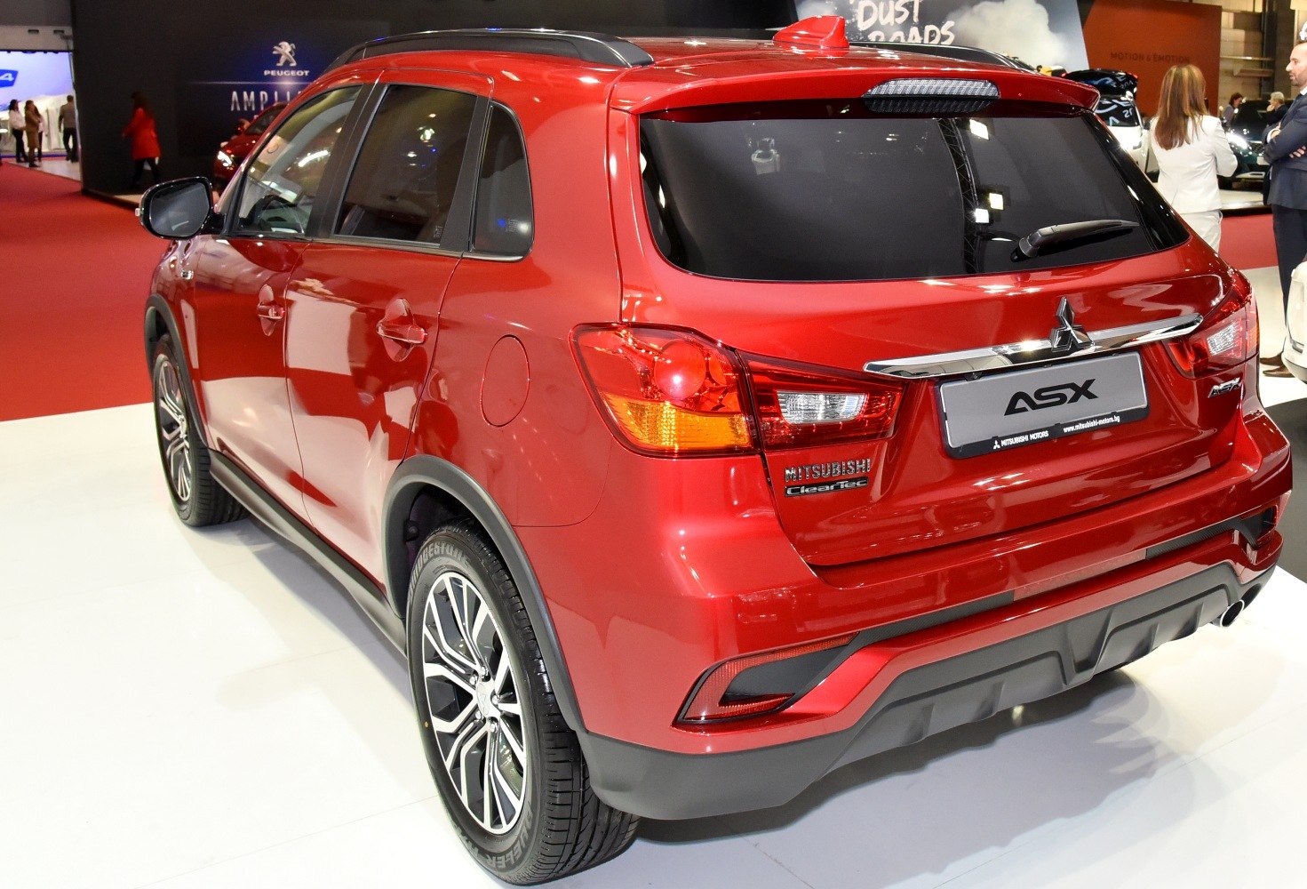Rear and side view of red SUV with stylish alloy wheels and roof rails