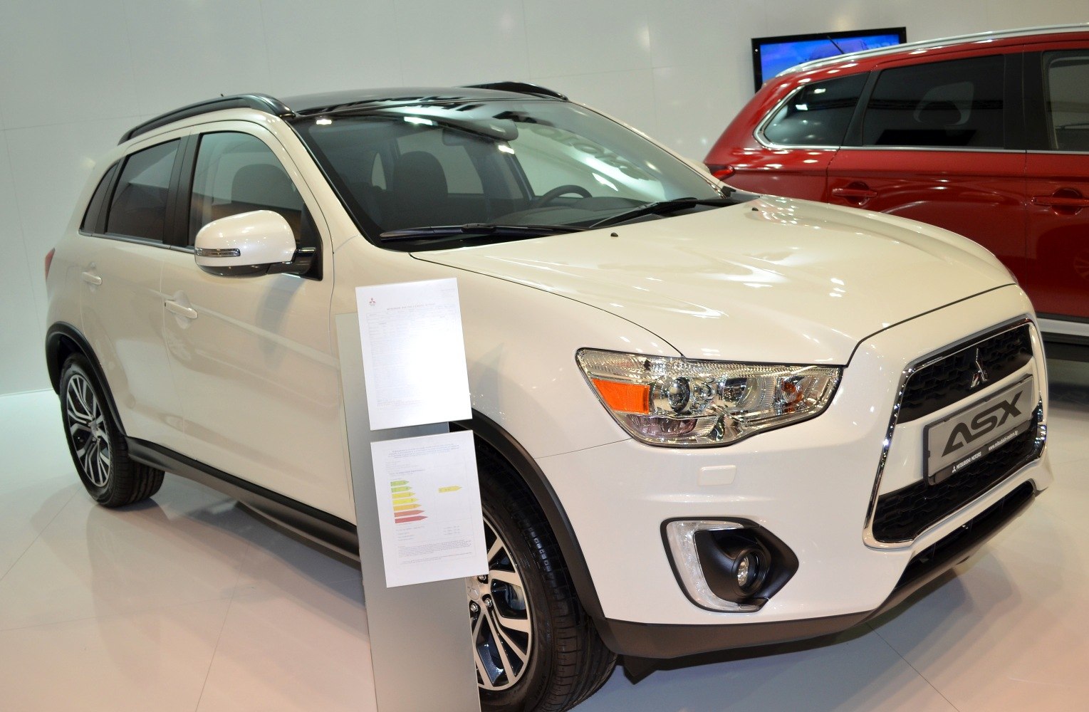 Front angled view with distinctive headlights, grille, and alloy wheels.