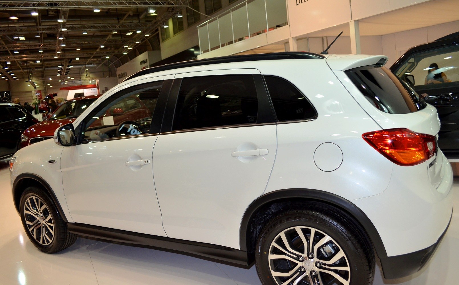White compact SUV side profile with alloy wheels and roof rails