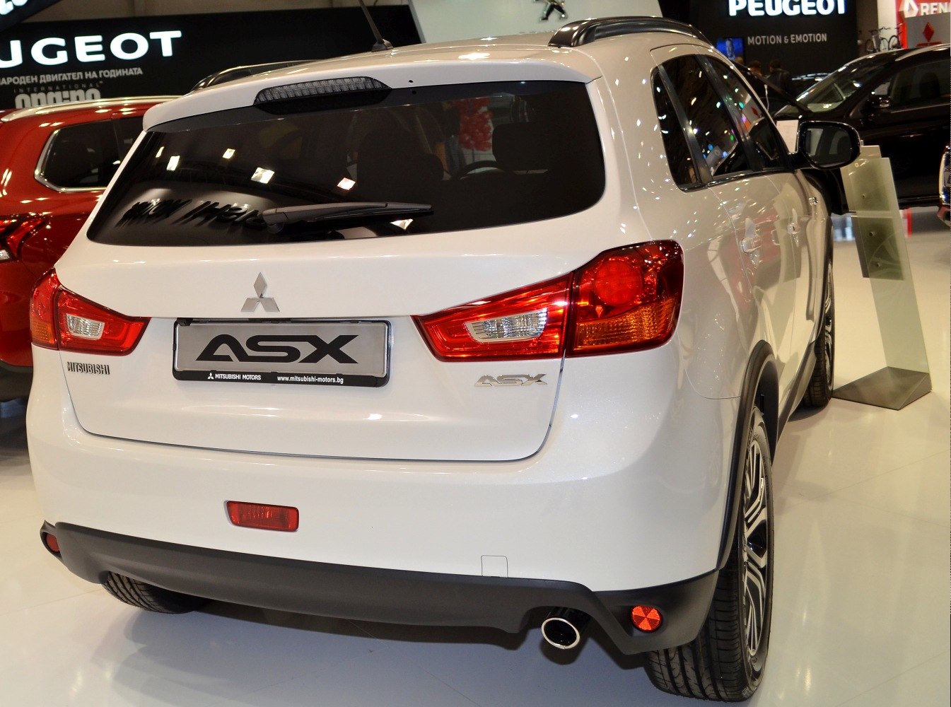 Rear view showing tail lights, rear window, and exhaust