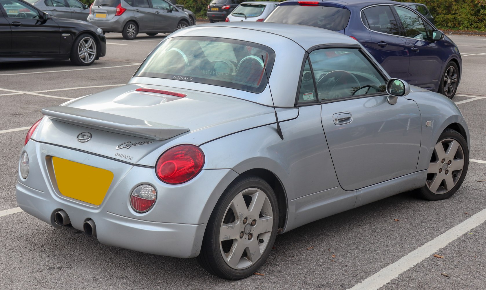 Rear view with spoiler and dual exhaust pipes