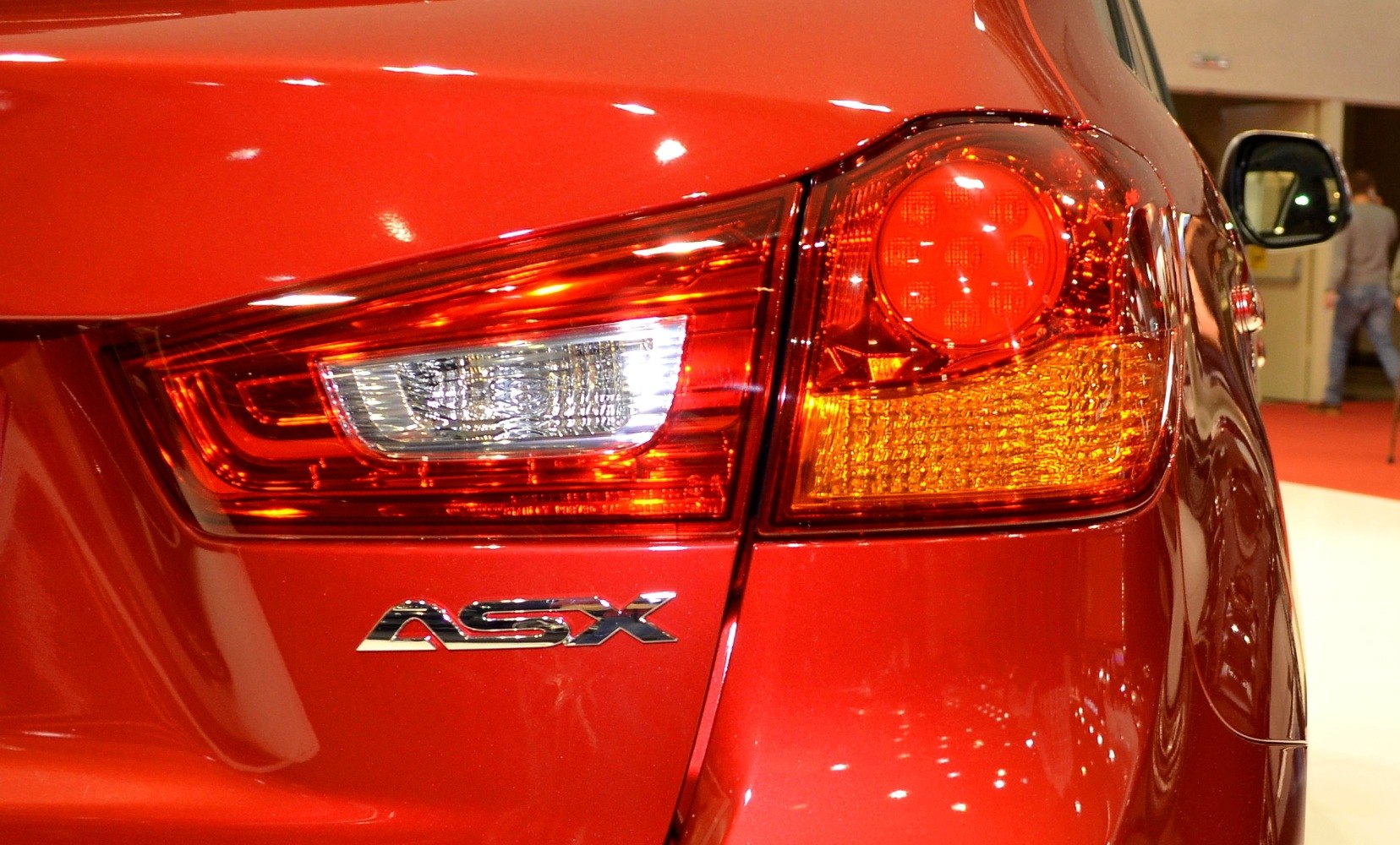 Close-up of rear tail light and ASX badge on red vehicle