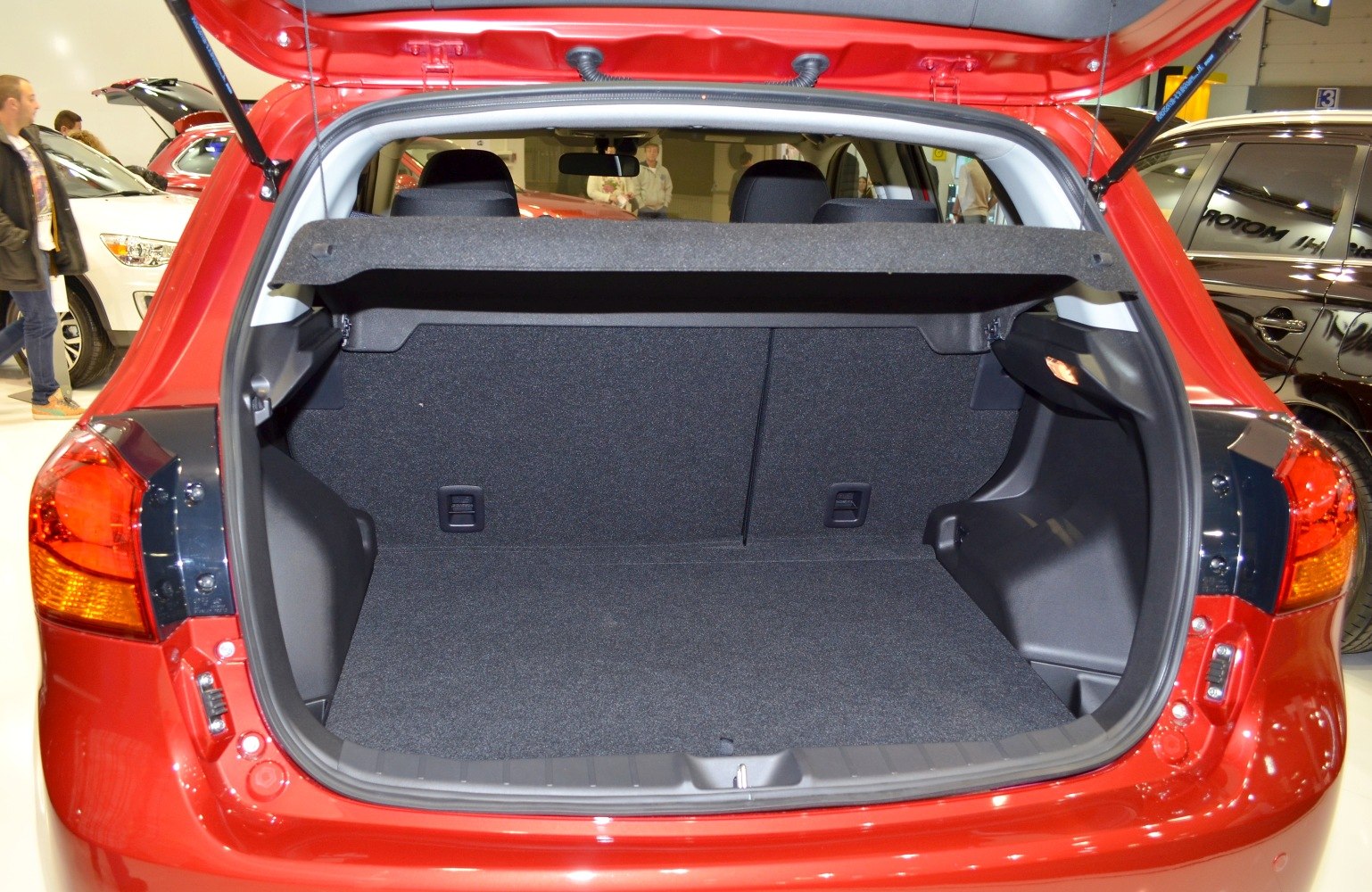Open rear hatch showcasing spacious carpeted trunk area