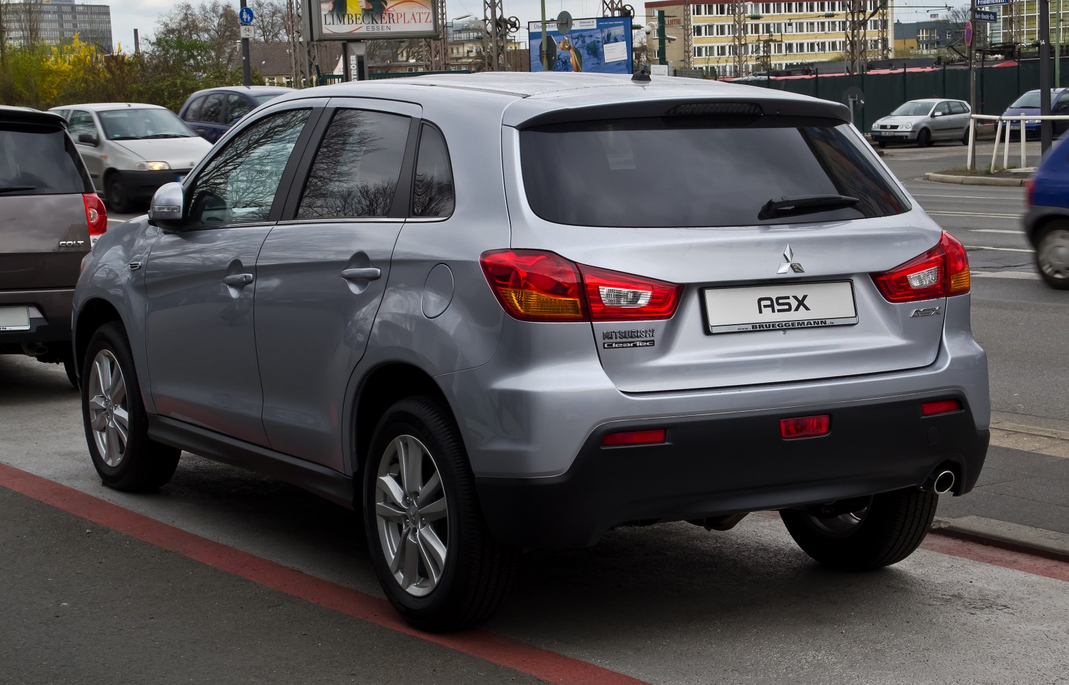 Rear side view of silver compact SUV with distinct tail lights and rear design