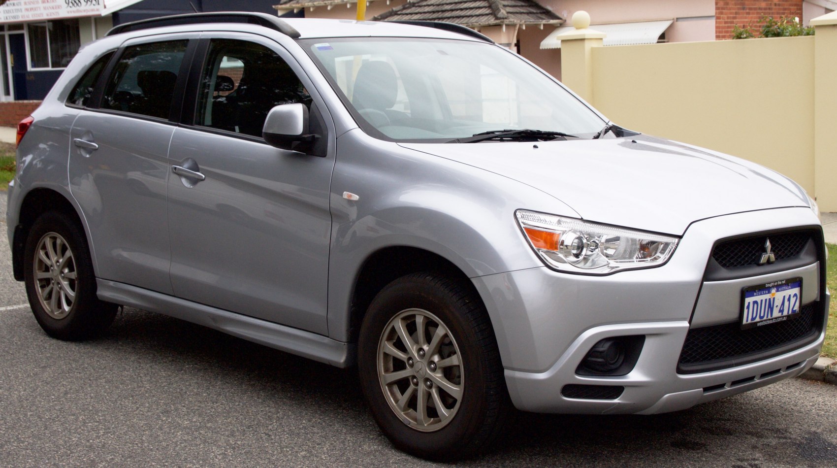 Silver compact SUV front side view with distinct headlights and grille