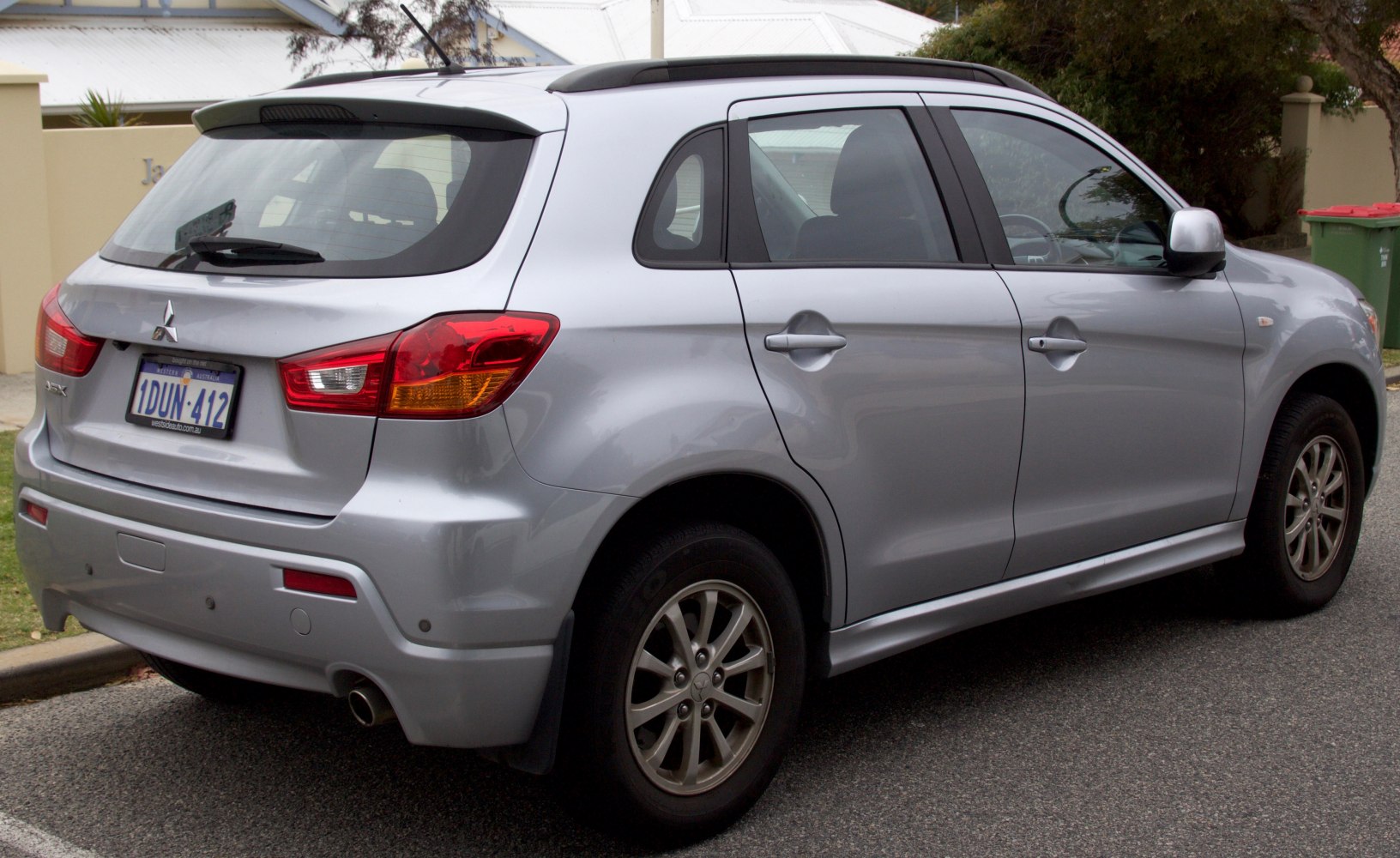 Silver compact SUV rear side with alloy wheels and rear spoiler