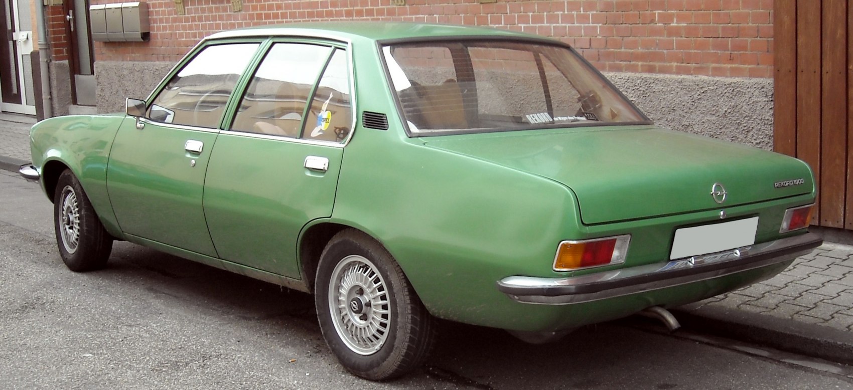 Vintage 1970s four-door sedan with chrome bumper and alloy wheels