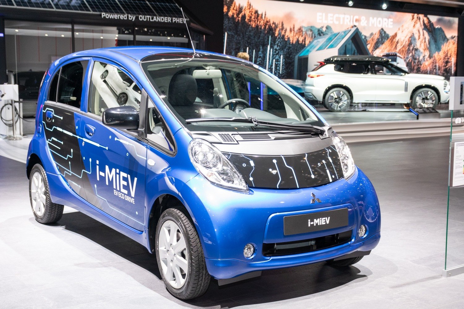 Blue electric hatchback with circuit-patterned hood and EV eco drive branding