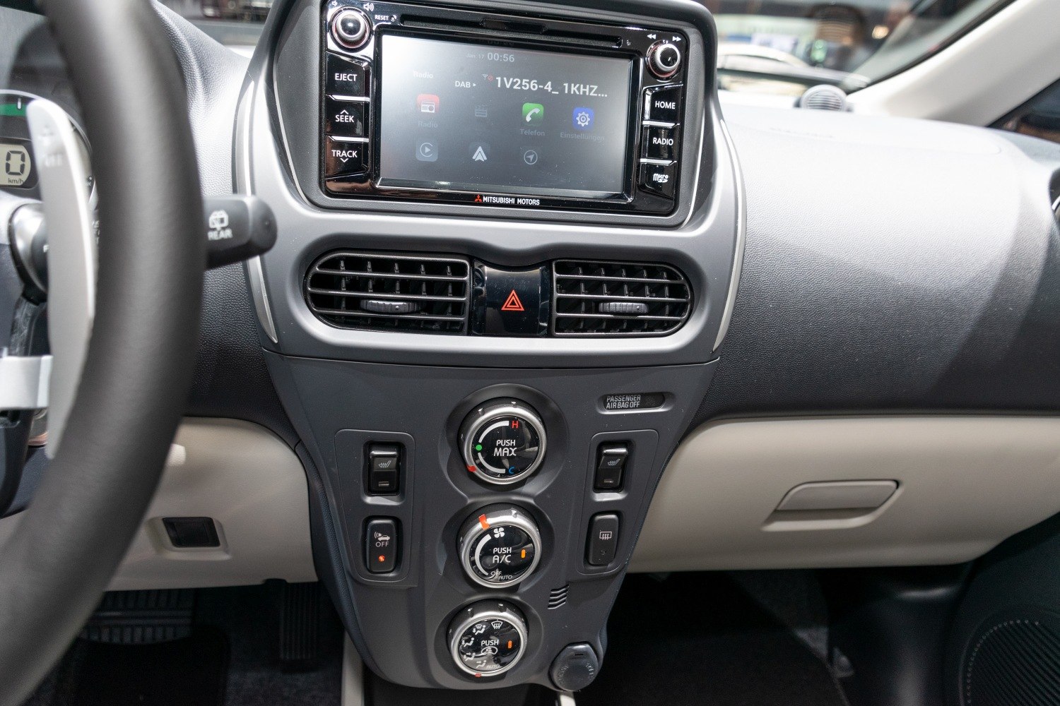 Central console with infotainment screen and climate control dials
