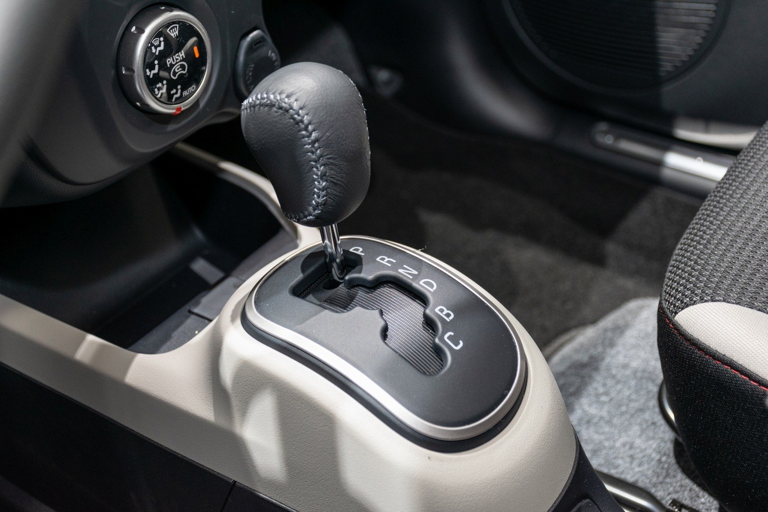 Close-up of gear shift lever and control knob on car console
