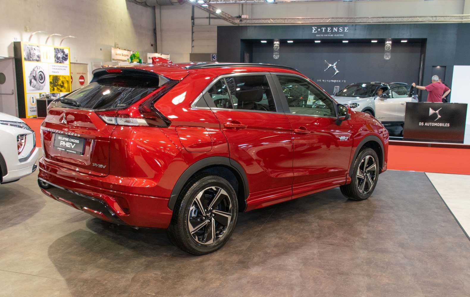 Rear-side view of red crossover SUV with distinct taillights and alloy wheels