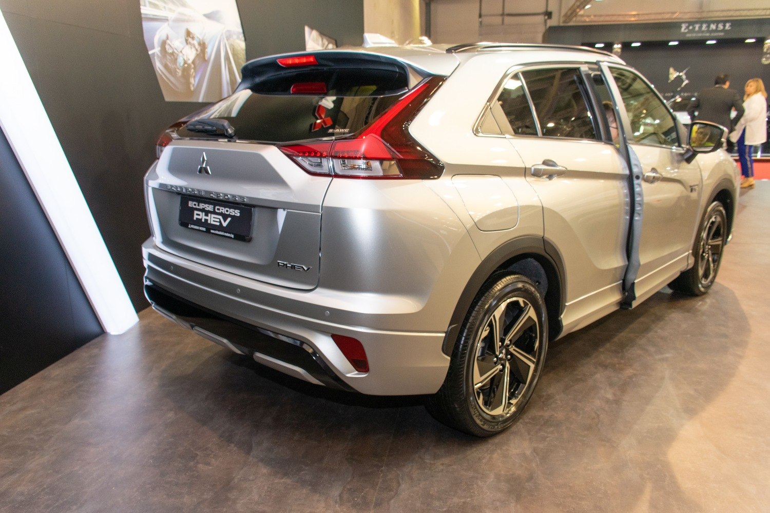 Rear view of a silver hybrid SUV with distinctive taillights and sporty alloy wheels