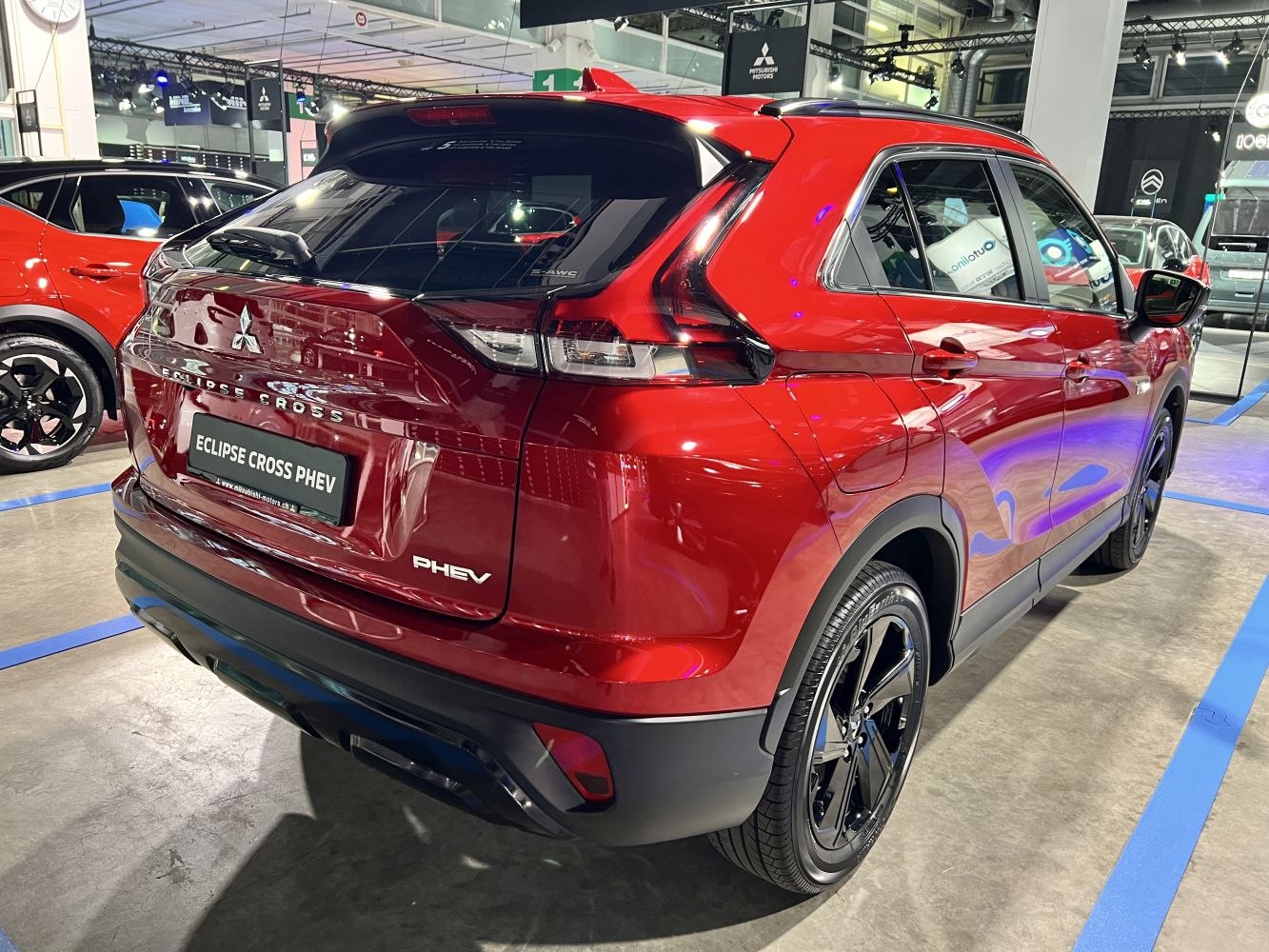 Rear view with unique tail lights and black alloy wheels.