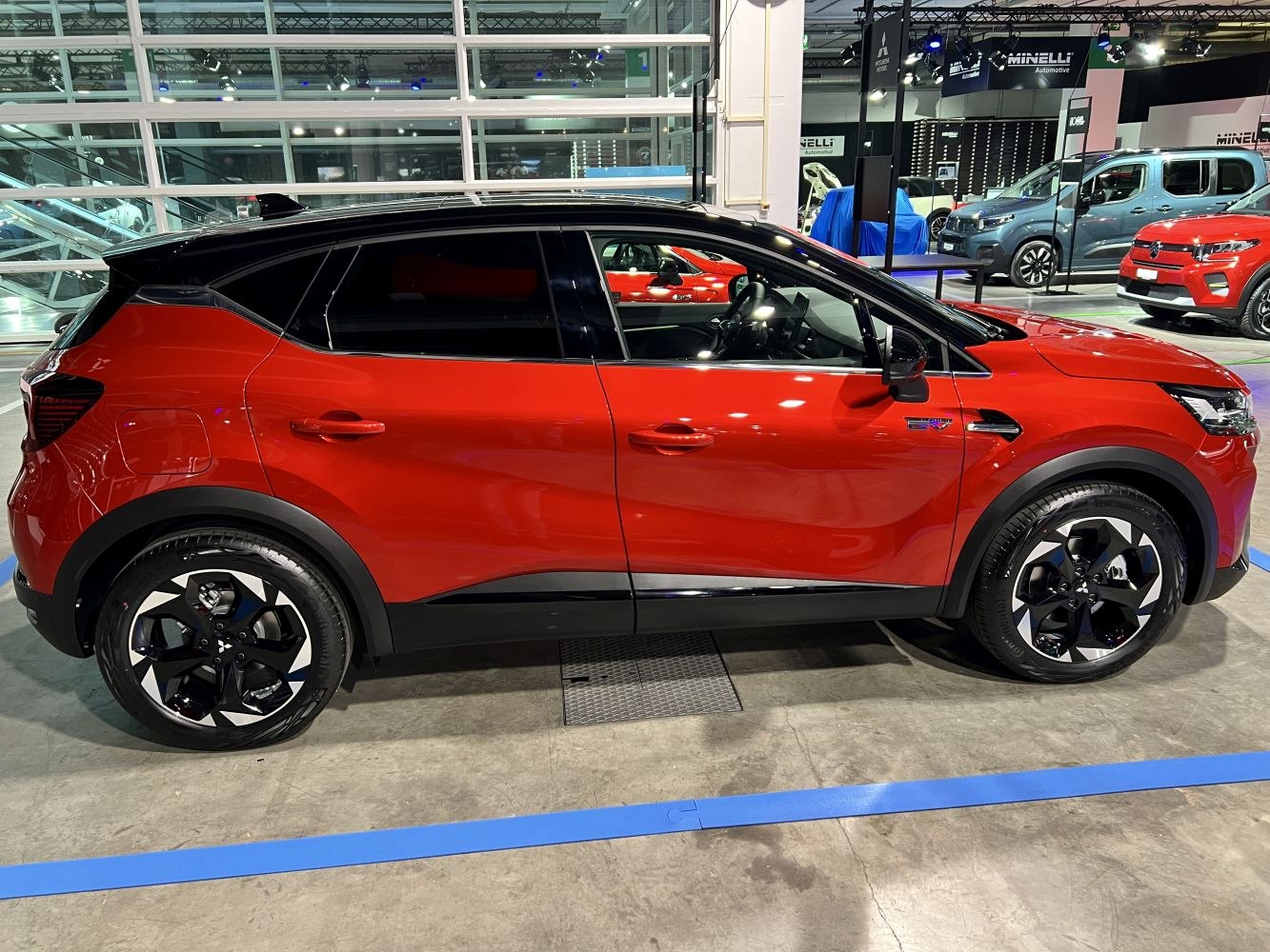 Side profile of SUV with black roof and alloy wheels