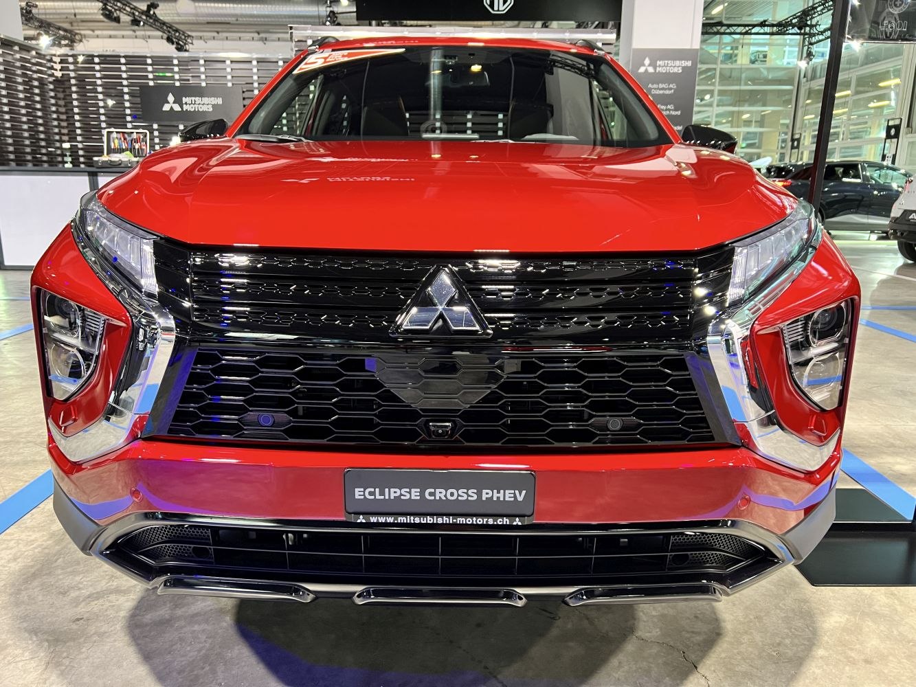 Front grille and headlight design of a red modern SUV