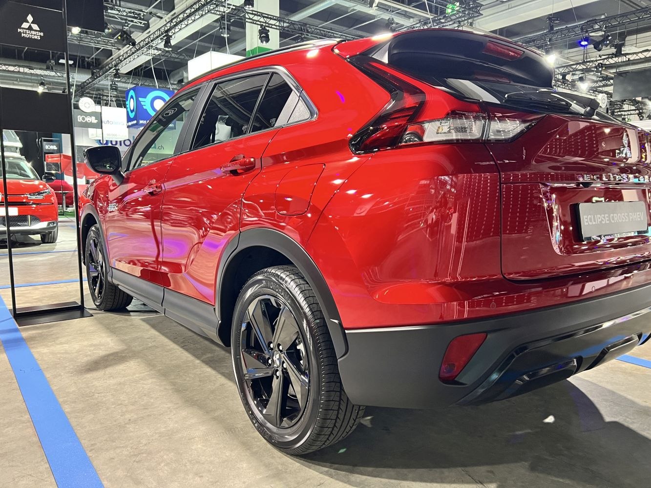 Rear and side view of red SUV with black wheels and distinct taillight design