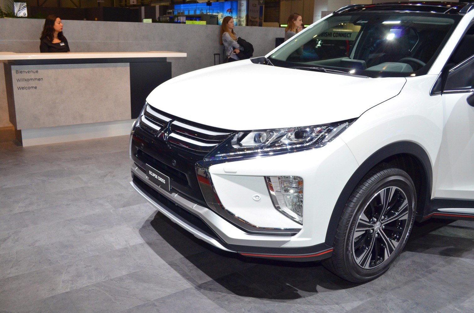 Close-up of front end and headlight design of a white SUV.