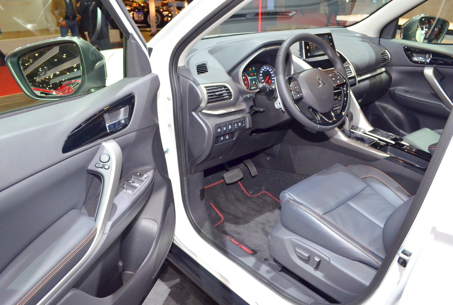 Driver side interior with seat, door panel, steering wheel, and dashboard.