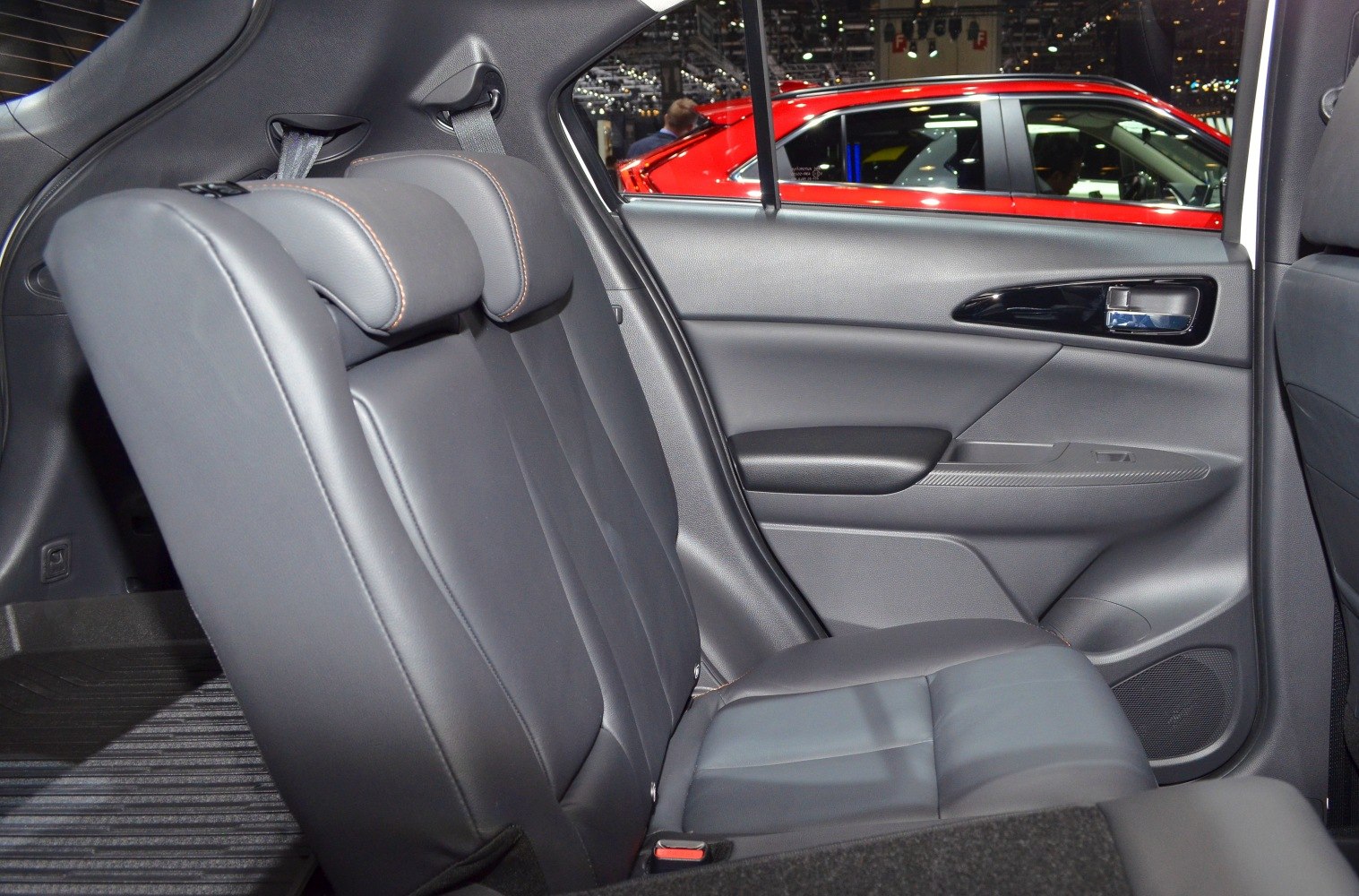 Rear seat with black leather upholstery and detailed stitching
