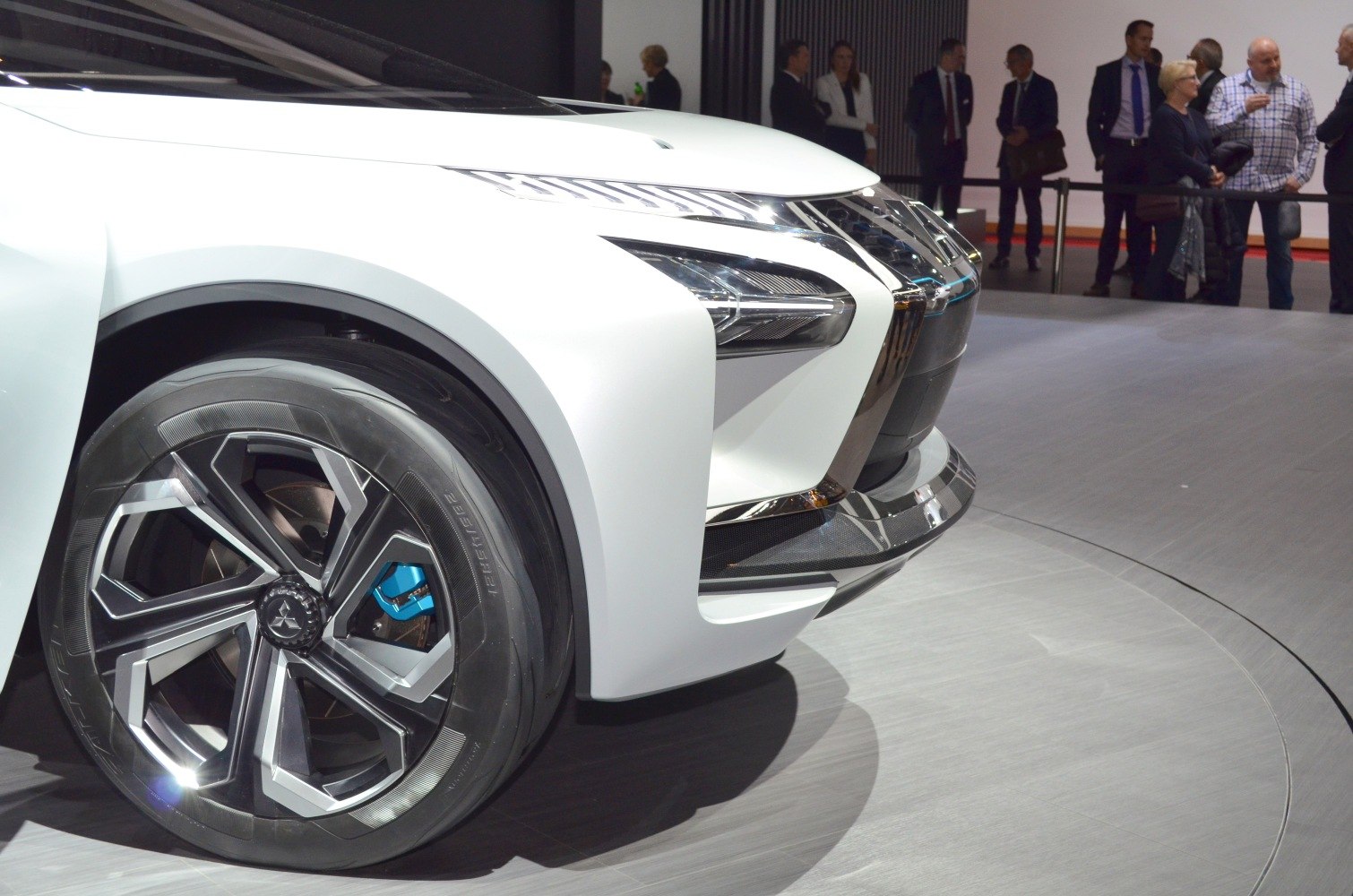 Futuristic front wheel and sharp LED headlight design with blue brake caliper