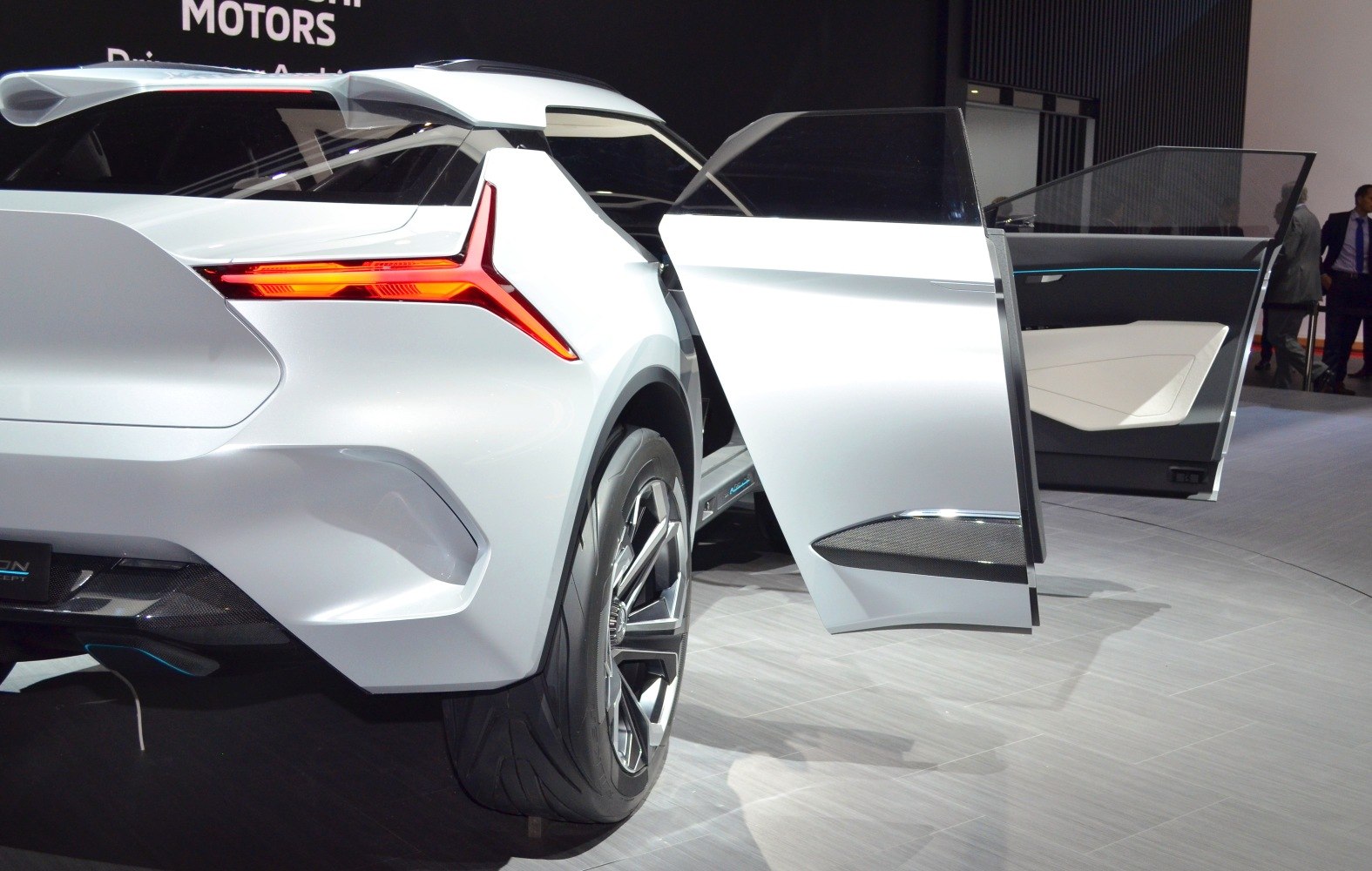 Futuristic rear taillight and uniquely designed rear wheel with open rear door.
