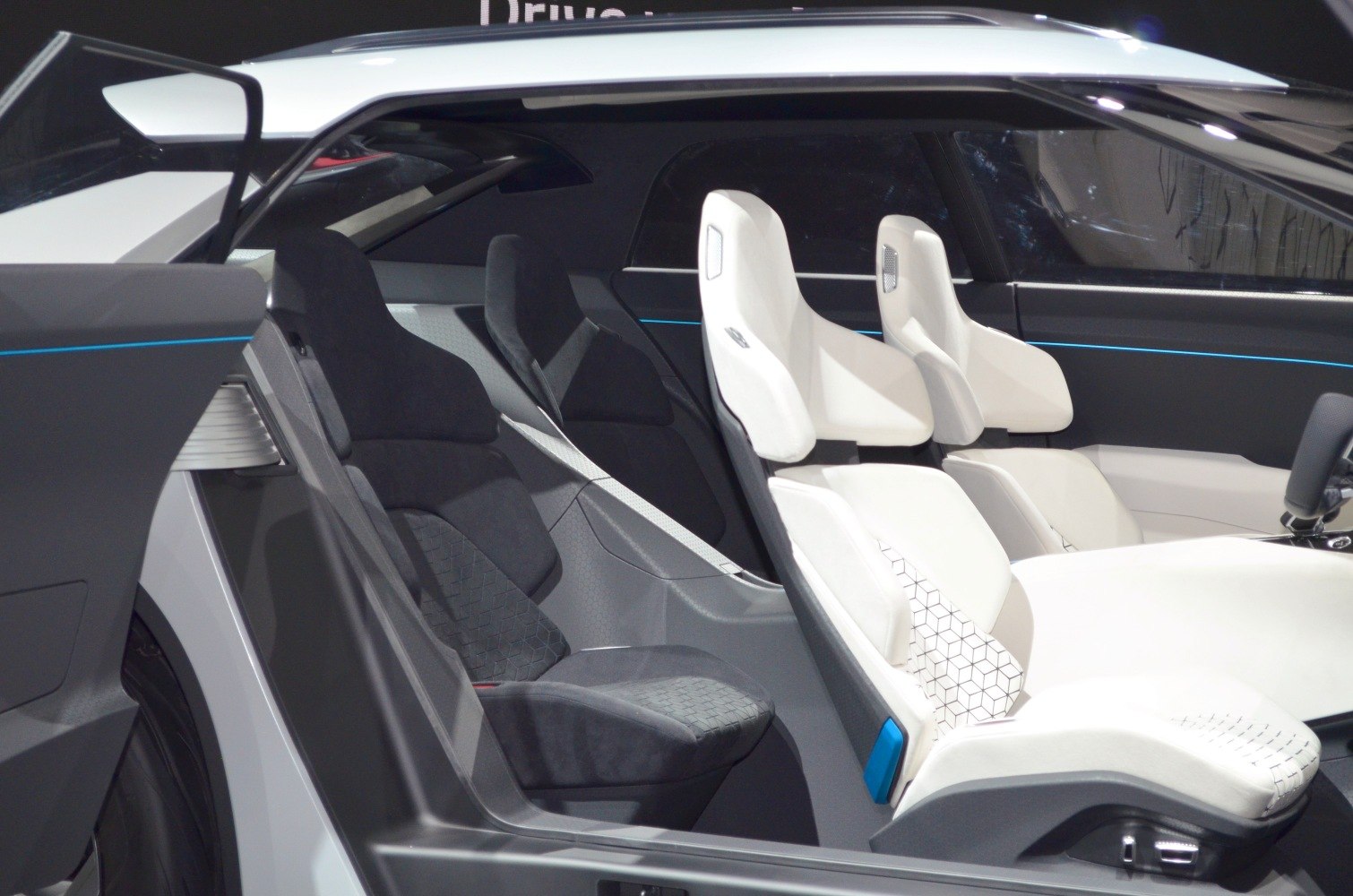 Contrasting white front seats and black rear seats in futuristic car interior