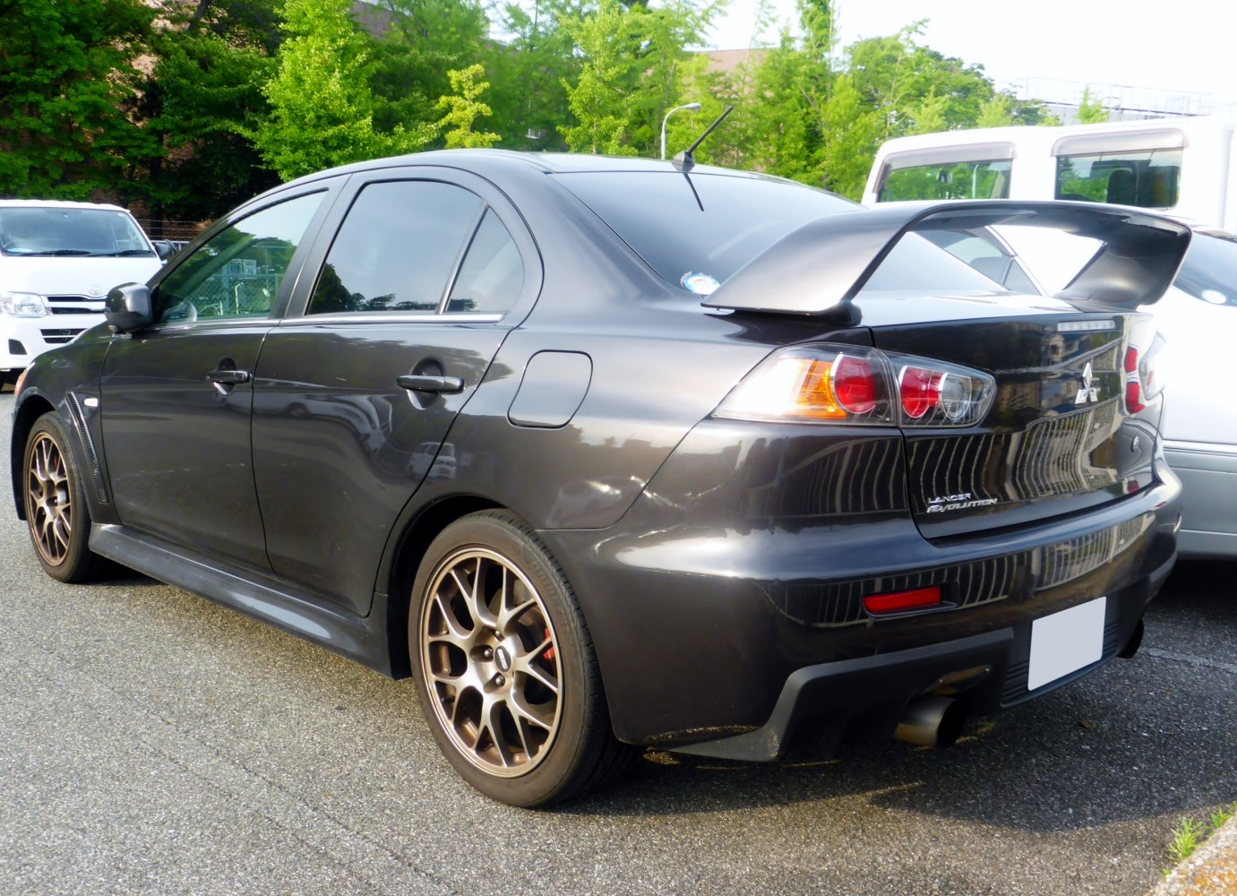 Rear side profile with large spoiler and alloy wheels