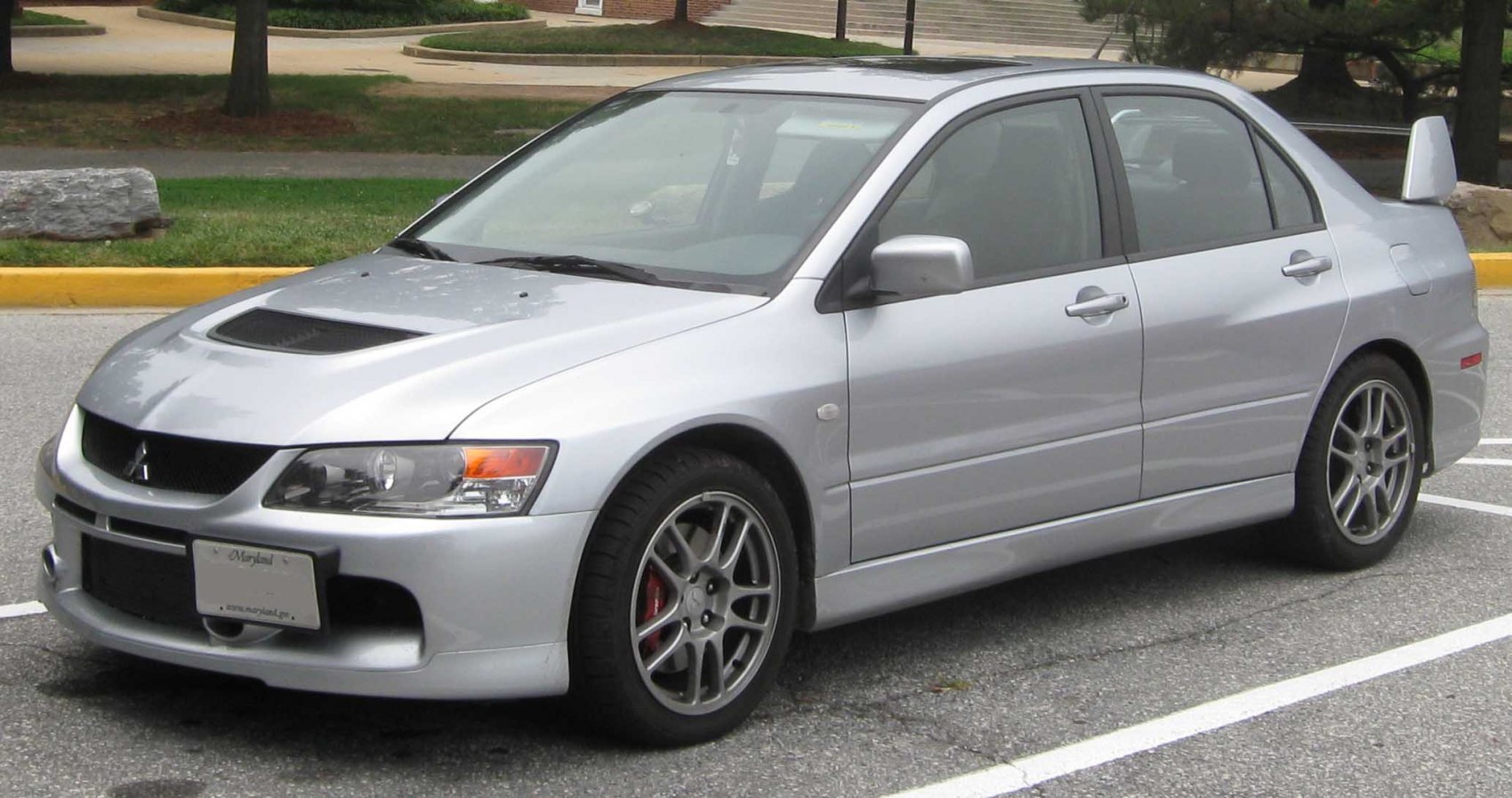 Silver sedan with hood scoop and large rear spoiler