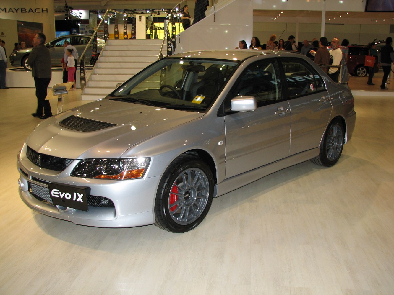 Front side view of sporty sedan with hood vent and alloy wheels