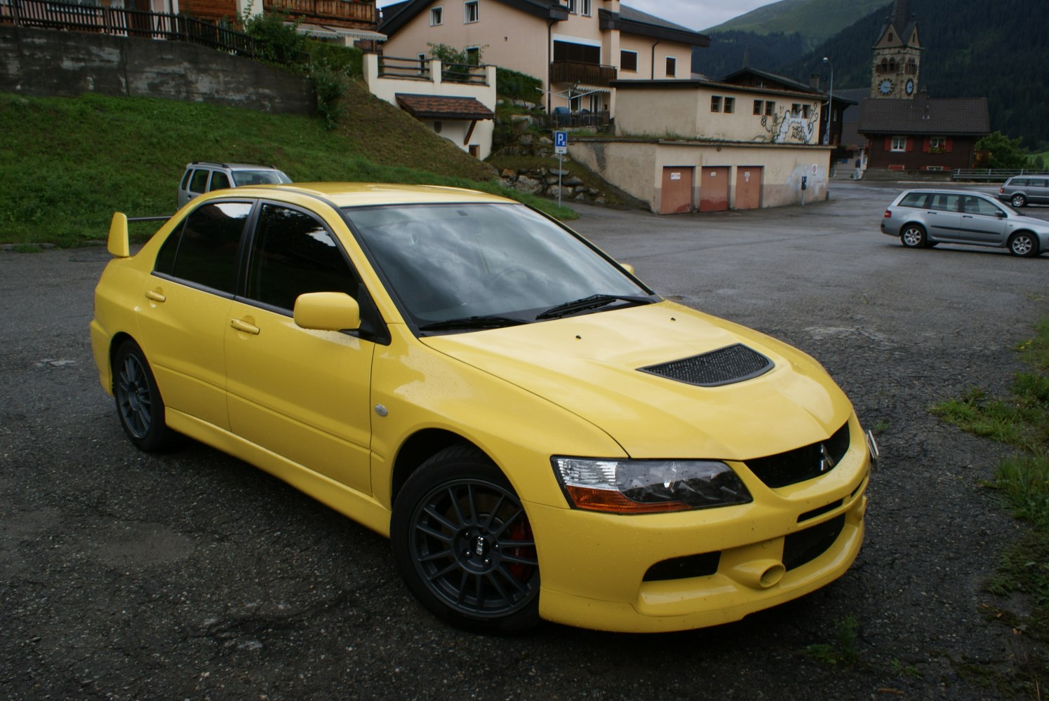 Yellow sedan with hood scoop and large rear wing