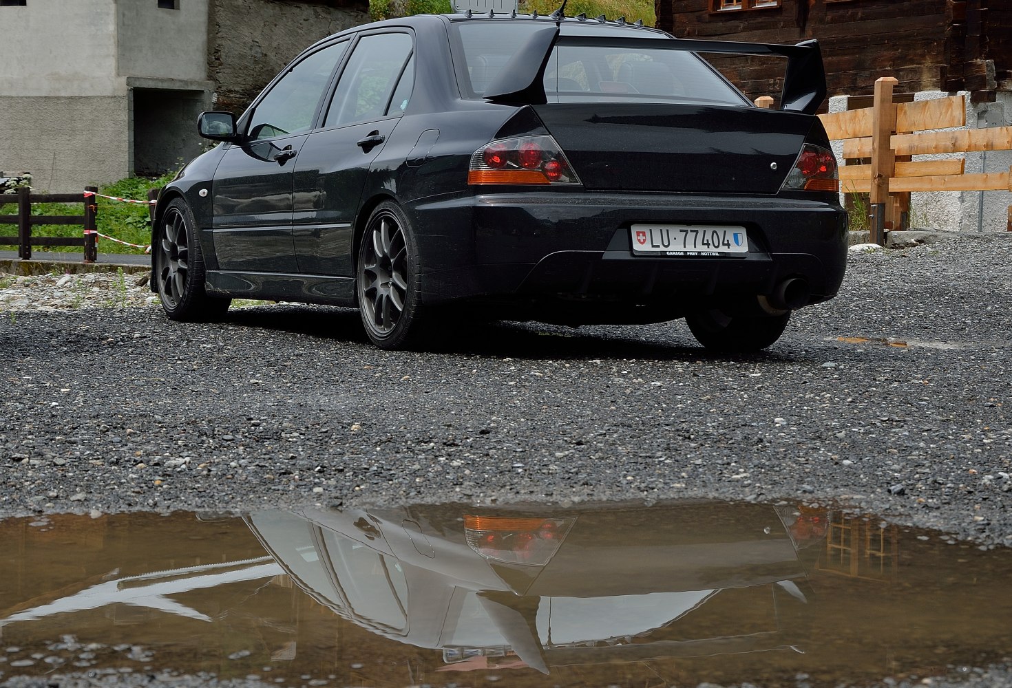 Rear view with large spoiler and sporty alloy wheels