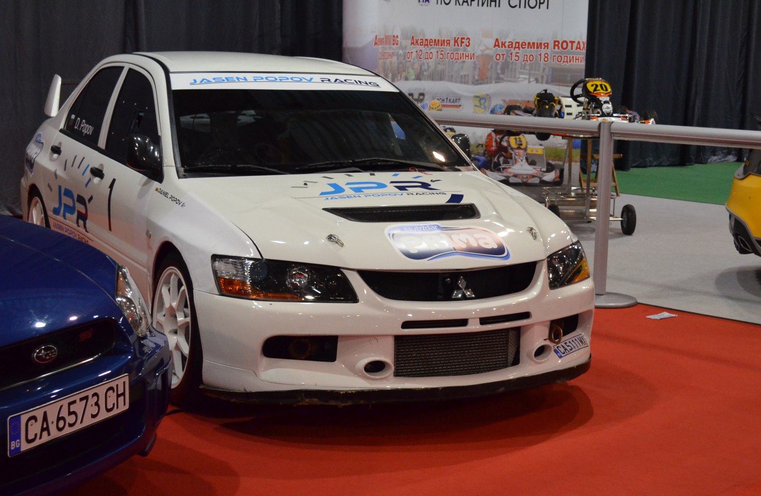 White rally racing front with hood vents and decals